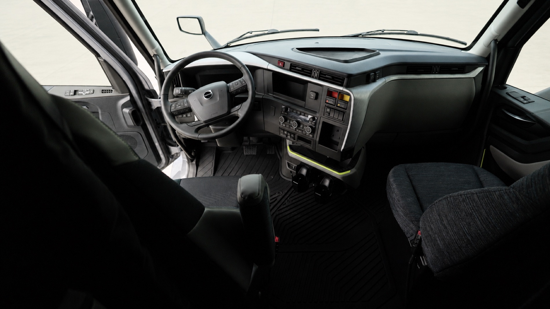 Full cab of a brand-new Volvo VNL — dash, wheel and both seats